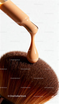 Liquid Foundation Droplet Above Soft Makeup Brush