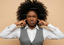 Frustrated Woman Covers Ears Against Noise in Business Attire