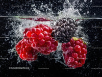 Fresh Blackberries and Raspberries Splashing in Water
