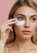 Close-up of a woman applying under-eye patch in skincare routine