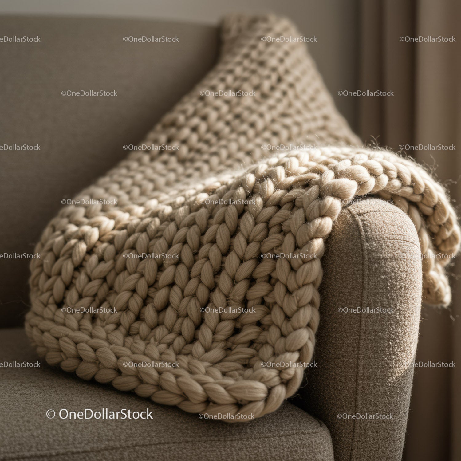 Cozy chunky knit blanket draped on sofa armrest
