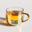 Elegant Clear Glass Tea Cup with Amber Liquid for Refreshing Drinks