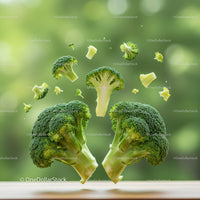 Fresh broccoli florets levitating over wooden surface