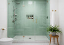 Modern bathroom with glass shower and green tiles