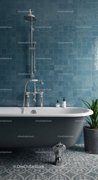 Classic clawfoot bathtub with blue tiled bathroom wall