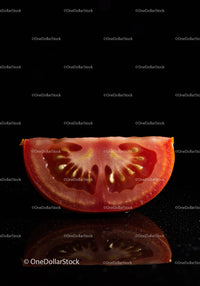 Fresh tomato slice with detailed seeds and reflection