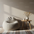 Cozy beige bean bag and wooden table with dried flowers