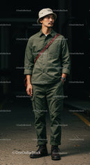Stylish Man in Green Cargo Outfit and Hat in Urban Setting