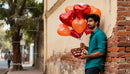 Man Holding Heart Balloons and Chocolates for Valentine