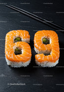 Salmon sushi rolls shaped as number sixty nine with chopsticks