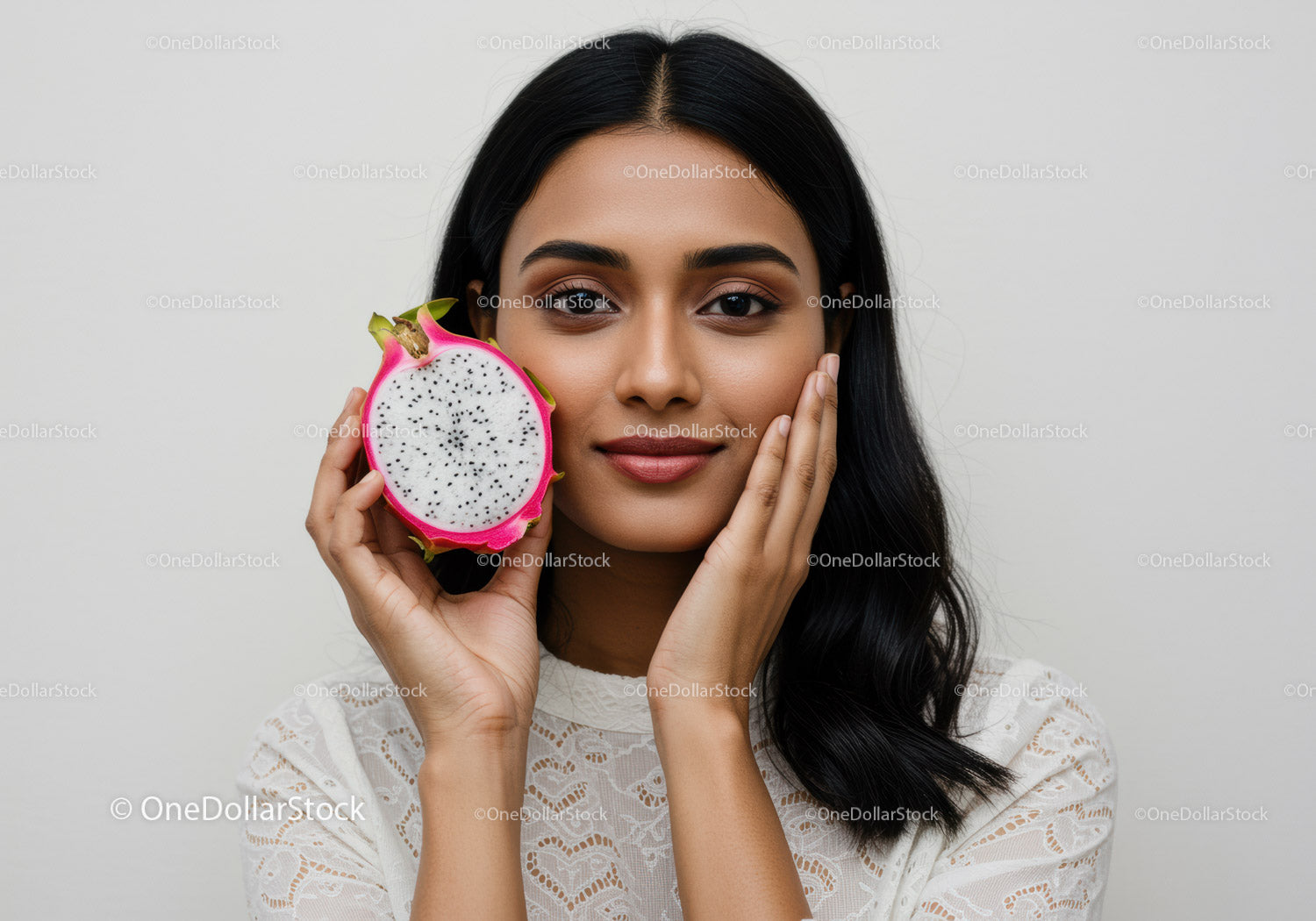 Young Woman with Radiant Skin Holding a Fresh Dragon Fruit