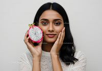 Young Woman with Radiant Skin Holding a Fresh Dragon Fruit