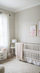 Bright Nursery Room with Baby Crib and Pink Floral Wall Art