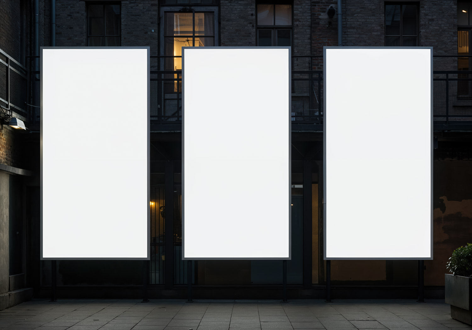 Three Blank Vertical Billboards Against Urban Building Facade
