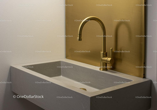 Modern Kitchen Sink with Gold Faucet and Concrete Countertop