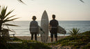 Two Surfers with Surfboards at Beach Ready for Waves