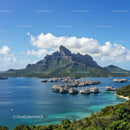 Tropical Mountain with Overwater Bungalows and Clear Blue Water