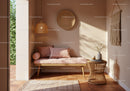 Cozy corner with soft pink daybed and natural decor