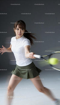 Focused female tennis player hitting forehand shot