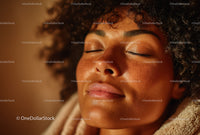 Close-up of a Relaxed Woman with Curly Hair and Natural Skin