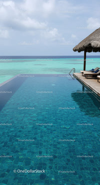 Luxury Infinity Pool Overlooking Turquoise Ocean and Tropical Sky