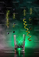 Suspended herbs and berries above decorative glass