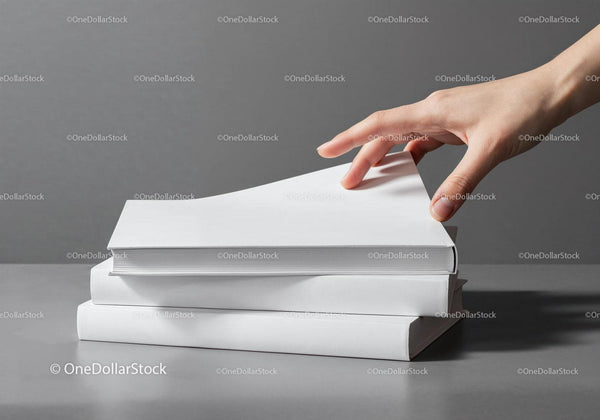 Hand Reaching for a Book from a Stack on Gray Surface JPG Mockup Image