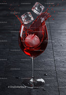 Red drink splashing with ice cubes in wine glass
