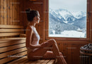 Serene Woman Sitting in Sauna With Mountain Snowy Landscape View