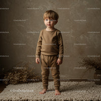 Toddler boy standing barefoot on soft rug indoors