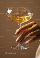 Elegant hand holding sparkling champagne glass