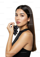 Elegant Woman Holding a Bunch of Black Grapes in Studio