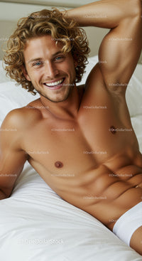 Smiling young man relaxing on bed in white underwear