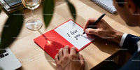 Man Writing Romantic Message in Valentine's Day Card