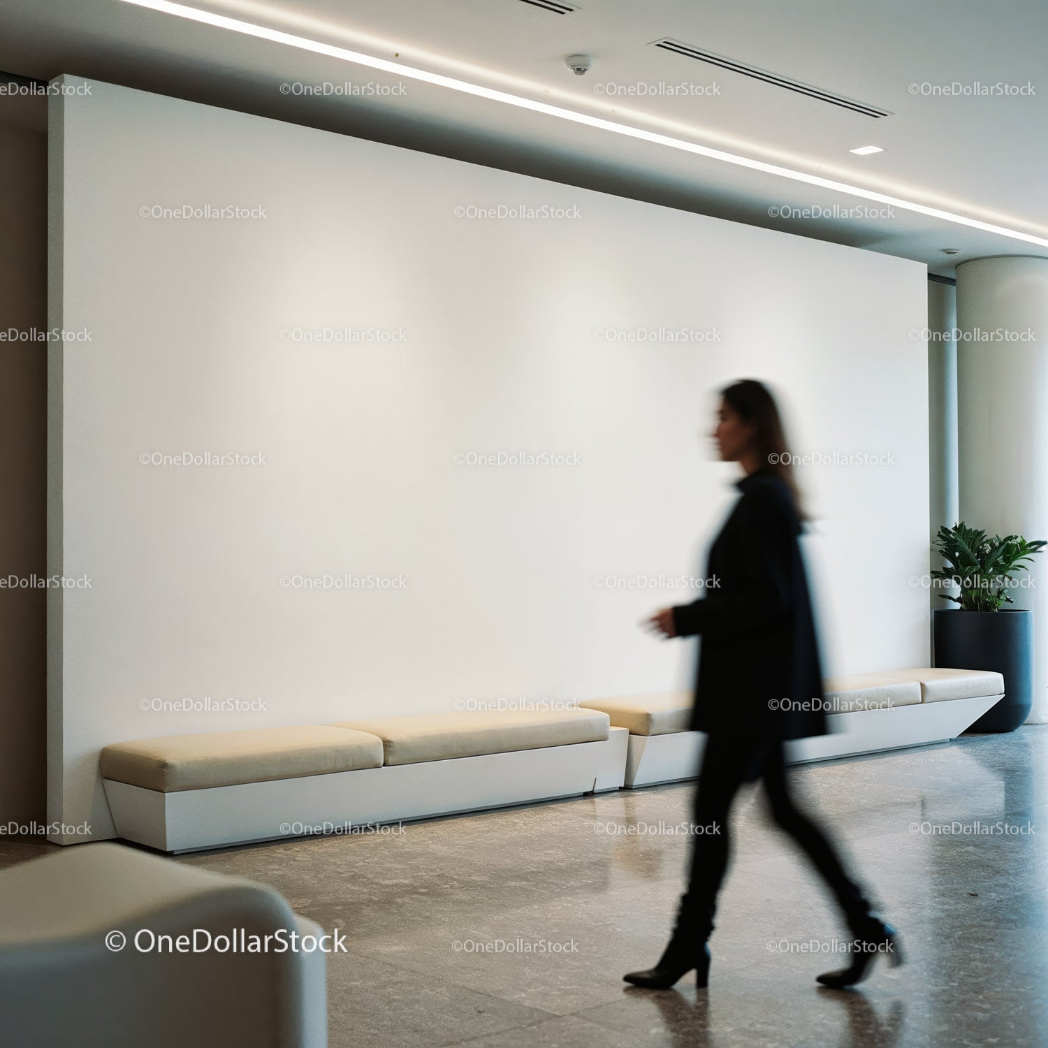 Blurred woman walking in a modern minimal lobby space