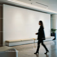 Blurred woman walking in a modern minimal lobby space