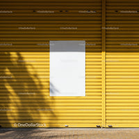 Urban yellow metal shutter with blank white poster