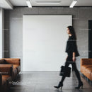 Blurred businesswoman walking past modern office seating