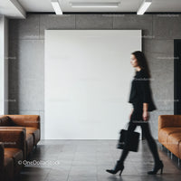 Blurred businesswoman walking past modern office seating