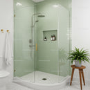 Modern glass shower with green tiles and natural decor