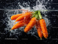 Fresh Orange Carrots Splashing in Water with Green Leaves