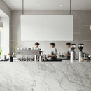 Busy Baristas Preparing Coffee Behind Marble Counter
