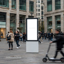 Busy urban square with blank digital advertising display