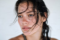 Close-up of a Young Woman with Freckles and Wet Hair