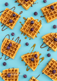 Delicious waffles with blueberries and drizzled syrup