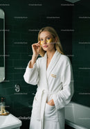 Elegant Woman with Gold Facial Masks in Spa Bathroom