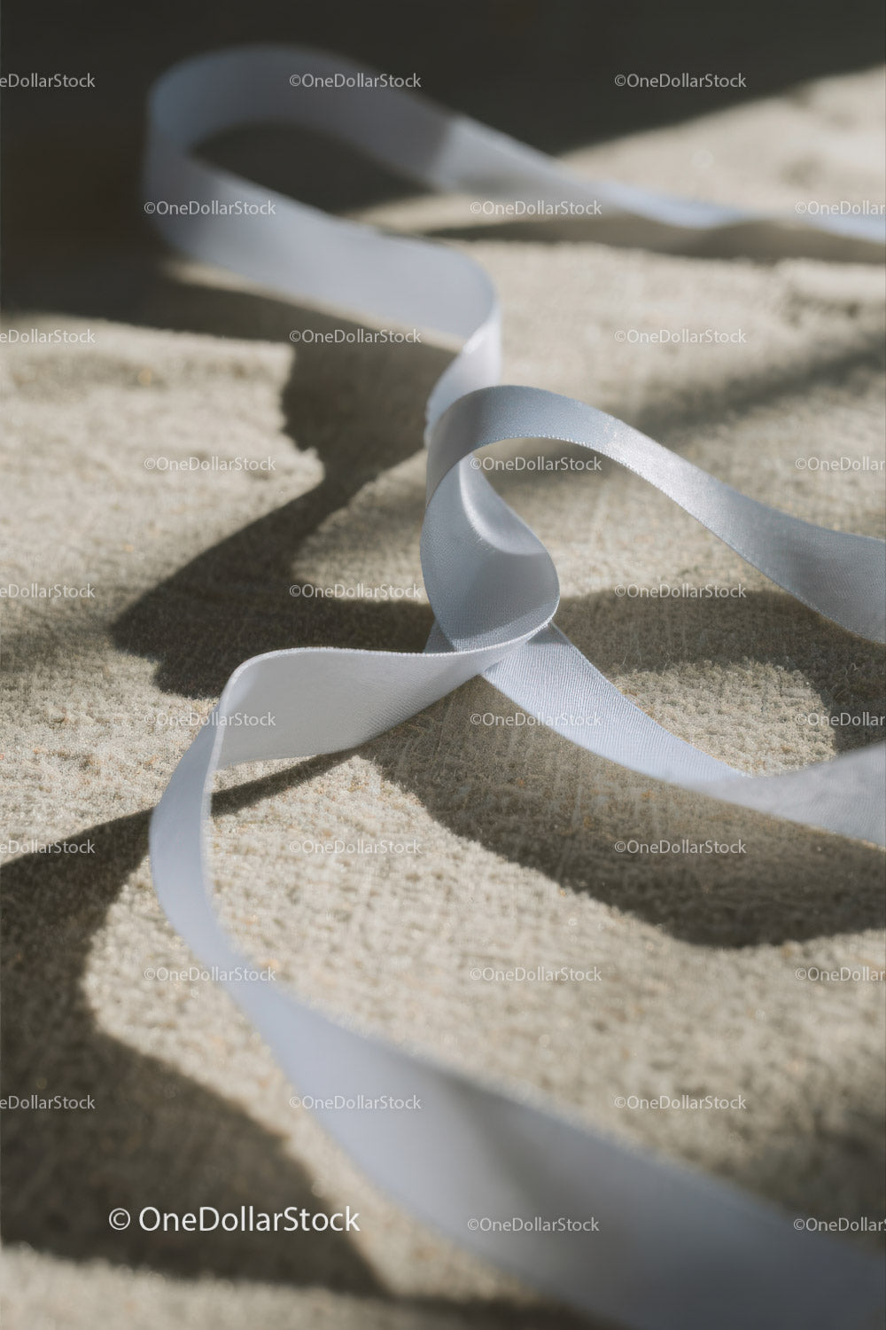 Close-up of White Plastic Ribbon Waste on Sandy Beach