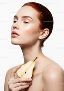 Elegant Woman with Pear Half in Hand and Flawless Skin