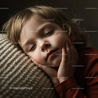 Peaceful child sleeping on knitted cushion indoors