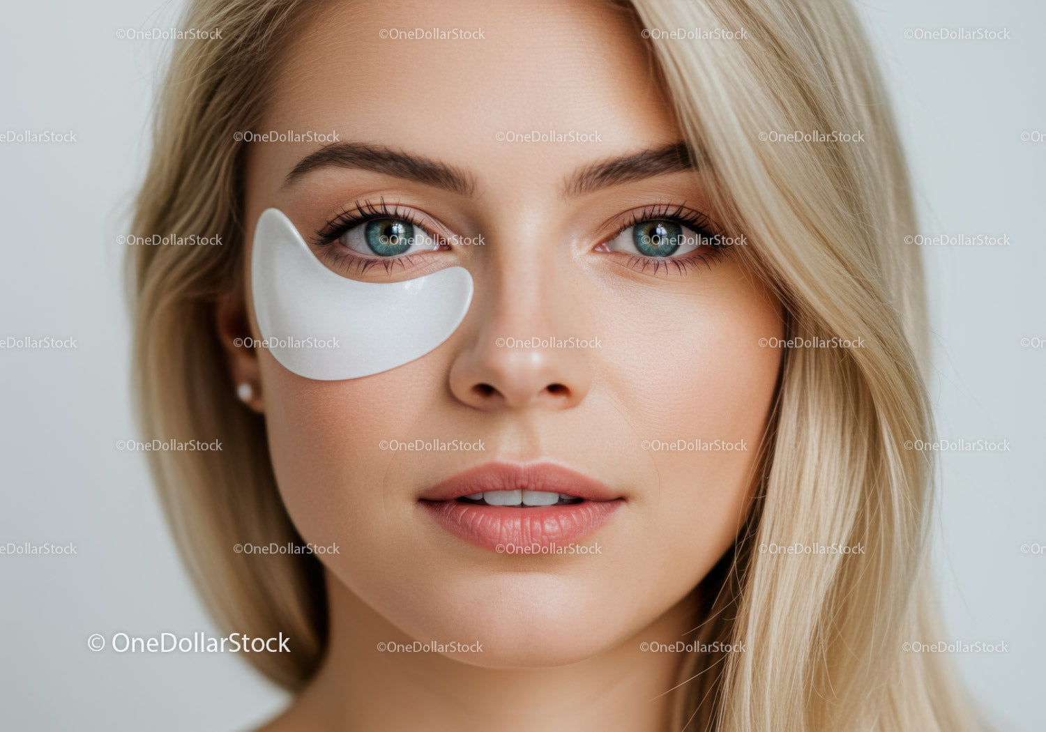 Young Woman with Clear Skin and Blue Eyes Wearing Under-Eye Patch